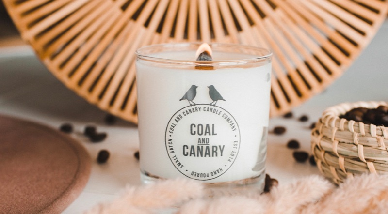 A lit Coal and Canary candle.
