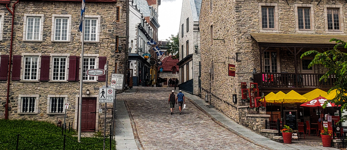 Stone buildings and cobble stone streets of a Quebec town in summer. 