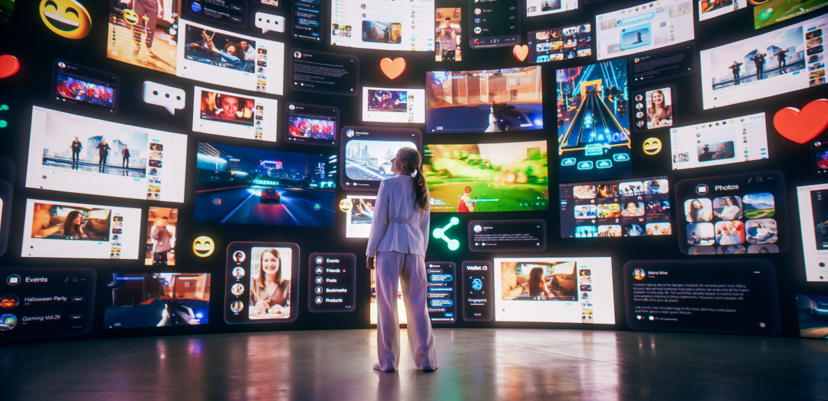 A woman stands in awe, facing a massive screen displaying a multitude of social media posts, videos and images.