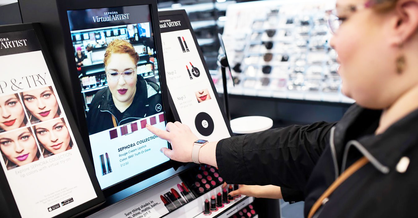 A young woman explores the Sephora Visual Artist app on a tablet in a Sephora store. Source: Perch Interactive.